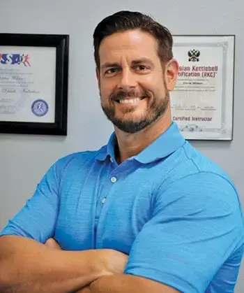 Certified balance specialist posing confidently in professional setting to represent expertise in balance and stability support